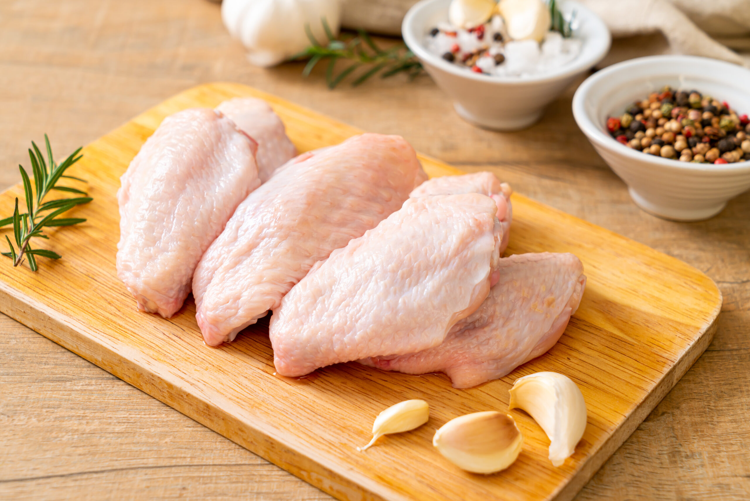 fresh raw middle chicken wings on wooden board
